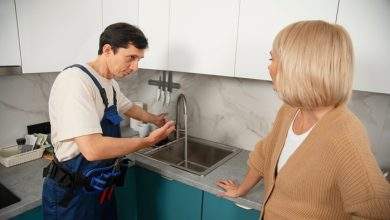 male plumber working with client fix kitchen problems 23 2150990686