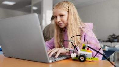 young girl using laptop electronic parts build robot 23 2149357689