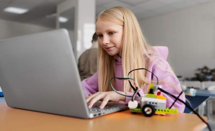 young girl using laptop electronic parts build robot 23 2149357689