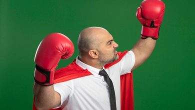 angry super hero businessman red cape boxing gloves raising hands showing strength courage winner concept standing green wall 141793 53601