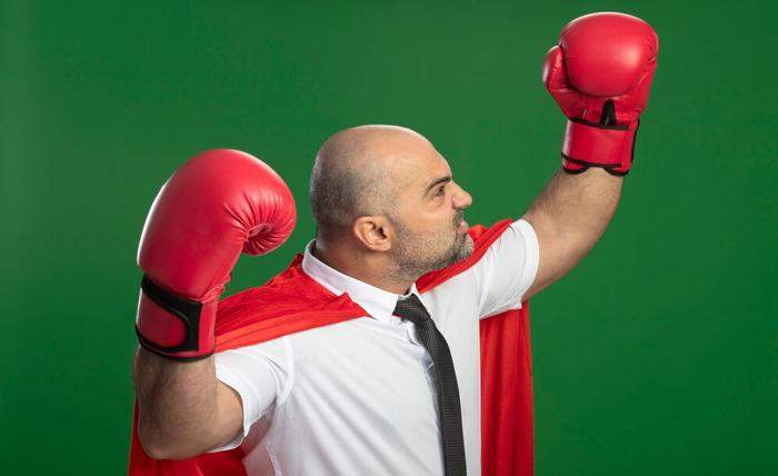 angry super hero businessman red cape boxing gloves raising hands showing strength courage winner concept standing green wall 141793 53601