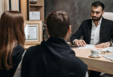 Specialized Attorney consulting with clients at an injury law firm after a serious accident.