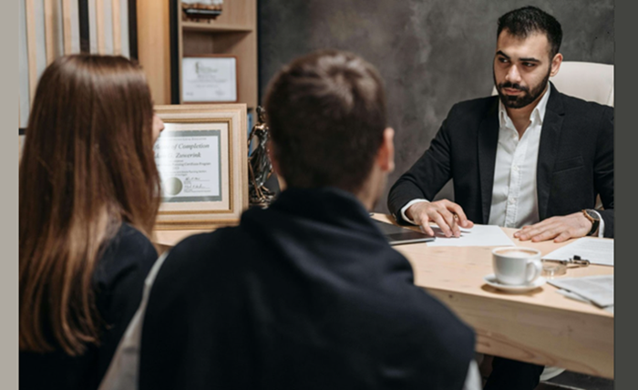 Specialized Attorney consulting with clients at an injury law firm after a serious accident.